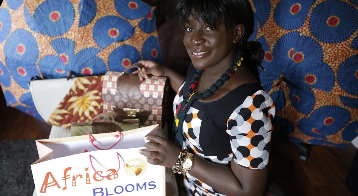 Image of Blooming hold her products from Africa Blooms