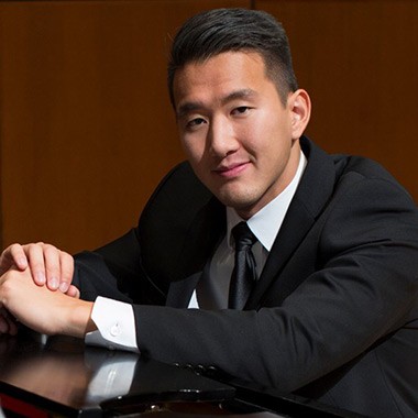 Profile image of B+MM alumni student, Terry Chen leaning on a piano