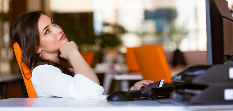 Female with phone and desktop computer.