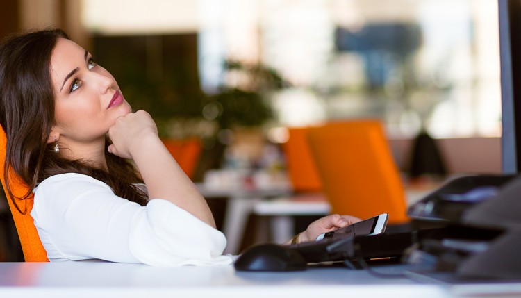 Female with phone and desktop computer.